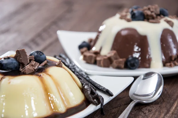 Different sorts of Pudding on wooden background — Stock Photo, Image