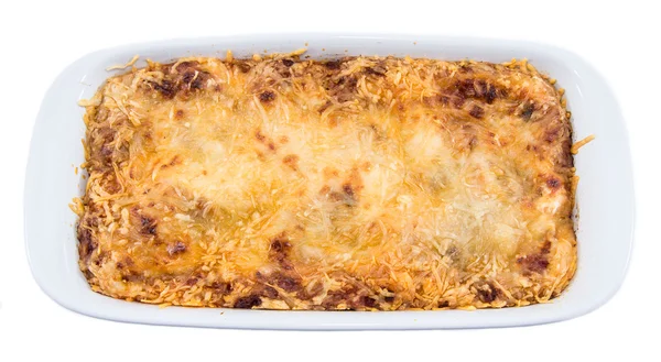 Portion Lasagne isoliert auf weiß — Stockfoto