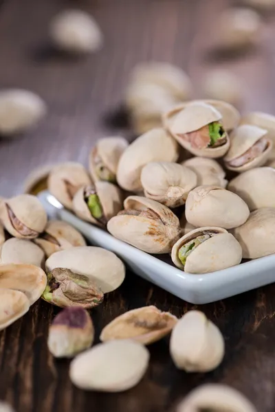 Pistachios on wooden background — Stock Photo, Image