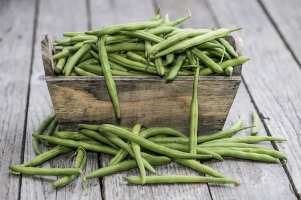 Some Green Beans on wood — Stock Photo, Image