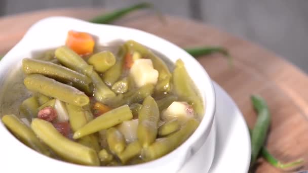 Вращающийся петельный суп из зеленой фасоли — стоковое видео