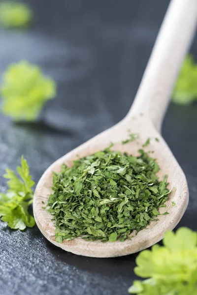 Dried Parsley on a wooden spoon — Stock Photo, Image