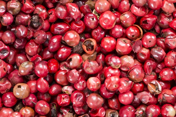 Imagen de fondo de granos de pimienta rosa — Foto de Stock