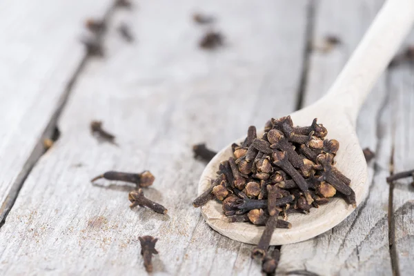 Cloves on a wooden spoon — Stock Photo, Image