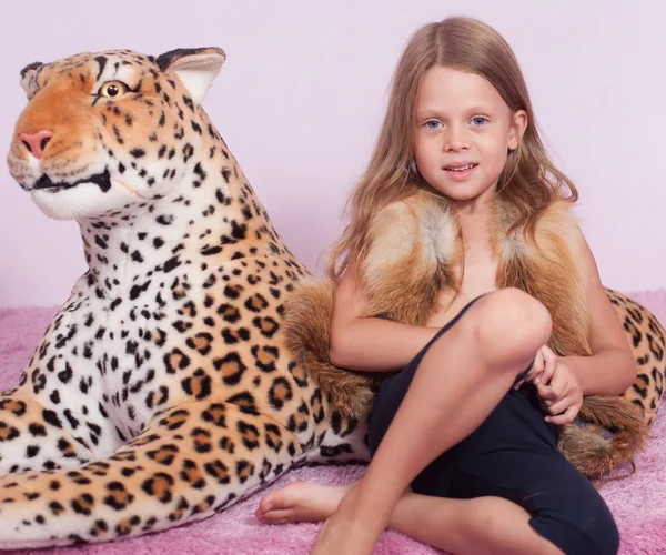 Little girl and toy leopard — Stock Photo, Image