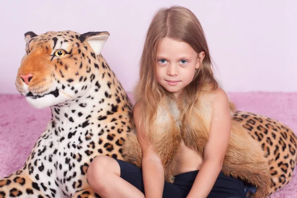 Little girl and toy leopard — Stock Photo, Image