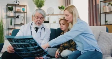 Yetişkin ve çekici bir annenin hızlandırılmış çekimi. Bunu da yetişkin sakallı bir doktorla tartışıyor. Doktor muayenesi sırasında oğlunun röntgen sonuçları.