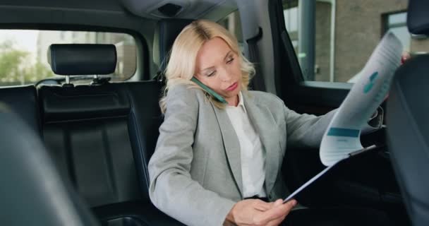 Gözlüklü Güzel Bir Kadını Çalışırken Pahalı Bir Arabanın Arka Koltuğunda — Stok video