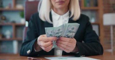 Portrait of beautiful happy successful female office manager which holding a lot of one hundred dollars banknotes ,her income as a result of effective work
