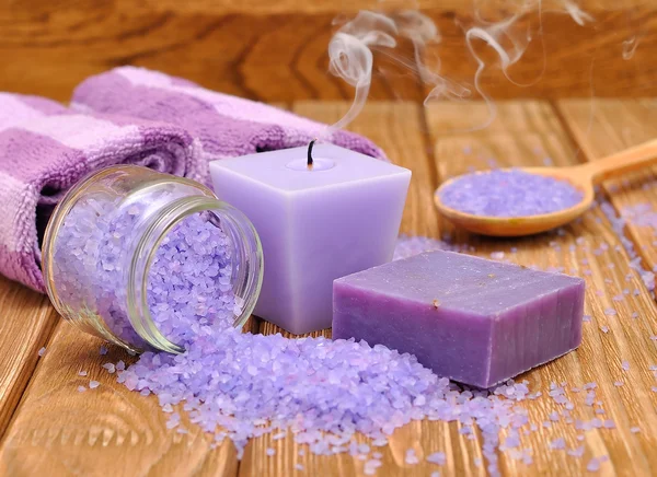 Purple candle and sea salt — Stock Photo, Image
