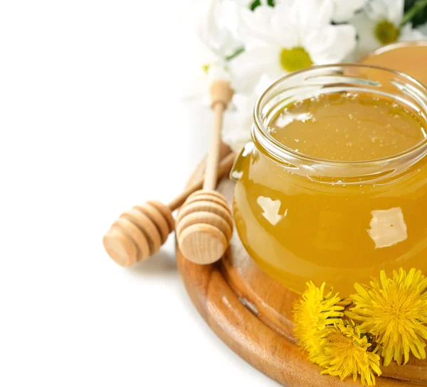 Honey and flowers on a white background — Stock Photo, Image