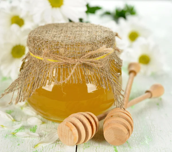 Honey and flowers on a white background — Stock Photo, Image