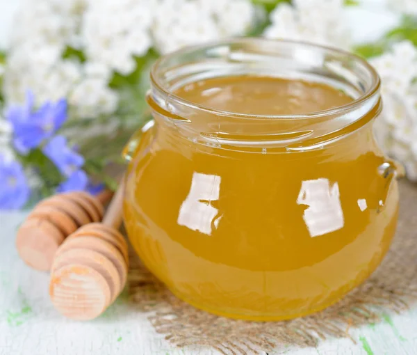 Miel en un frasco de vidrio — Foto de Stock