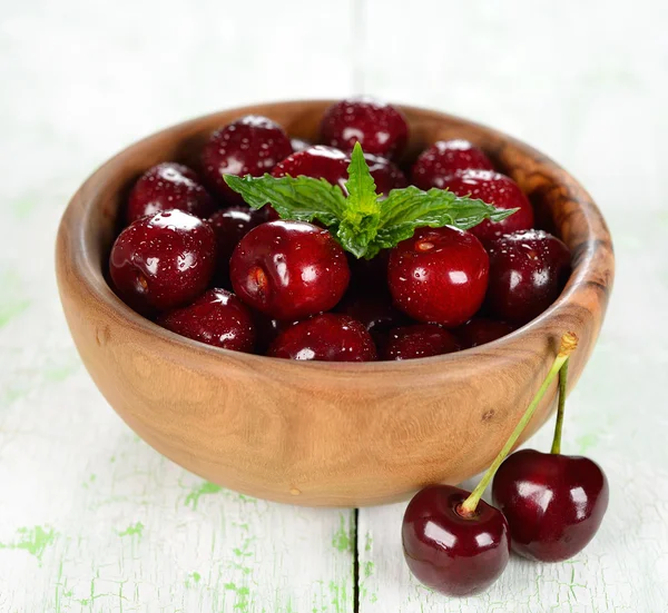 Fresh cherries in a wooden bowl — Stock Photo, Image