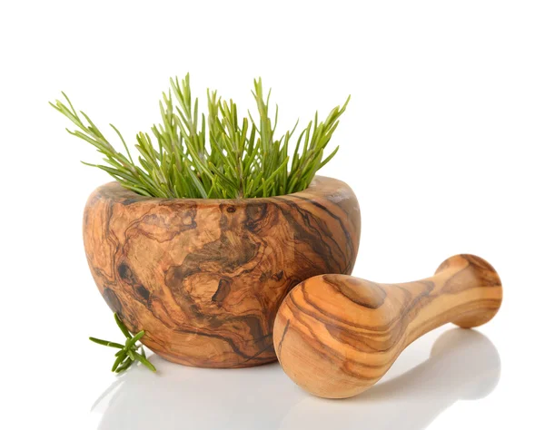 Rosemary in a wooden mortar — Stock Photo, Image