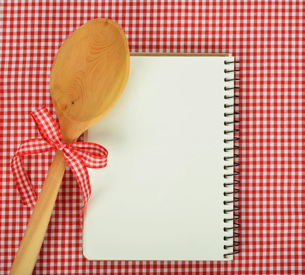 Notebook and wooden spoon — Stock Photo, Image