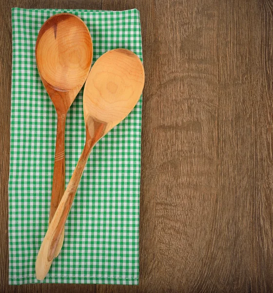 Wooden spoon on green napkin — Stock Photo, Image