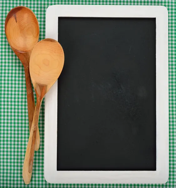 Writing board and wooden spoons — Stock Photo, Image