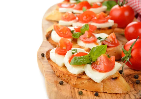 Bruschetta with mozzarella and tomatoes — Stock Photo, Image