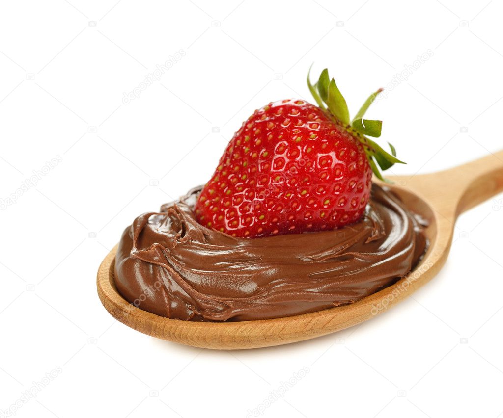 Chocolate sauce with strawberries in a wooden spoon