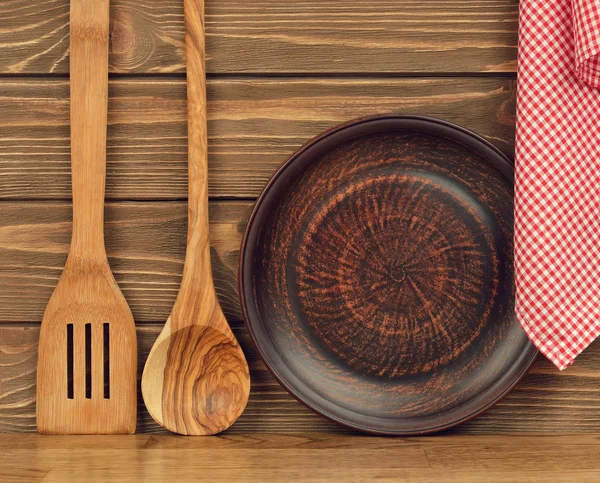 Wooden spoon, plate and napkin — Stock Photo, Image