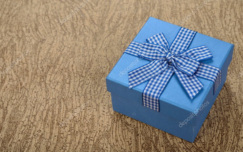 Blue box decorated with ribbon Stock Photo by ©Olyina 47293389