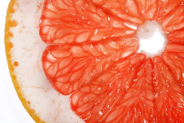 Slice of grapefruit isolated on white background- closeup. — Stock Photo, Image