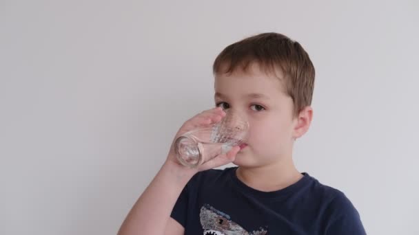 Niño bebiendo agua de un vaso — Vídeos de Stock
