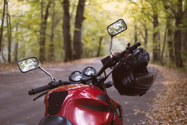 Motorcycle with helmet in the autumn forest close up — Stock Photo, Image