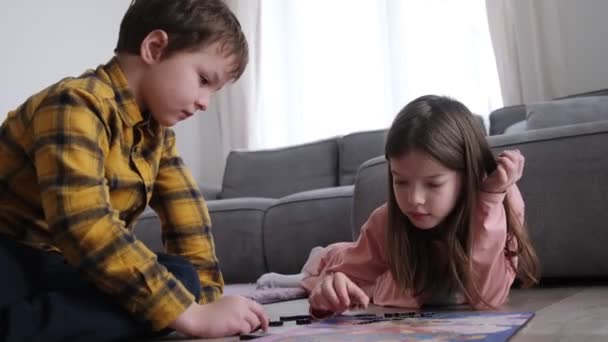 Little children collect wooden puzzles, educational game — Stockvideo