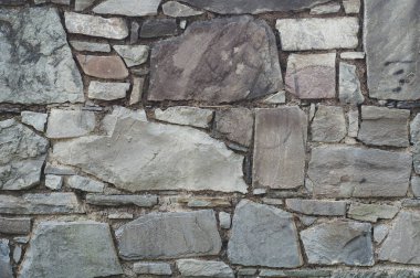 Arka planda iyi yontulmuş taşlar farklı boyutlarda, düz yüzey eski duvar, yakın plan eski doku arka plan, pis bina cephesi.