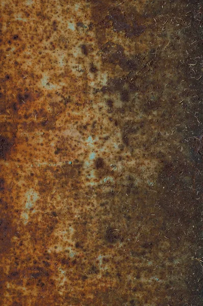 Rusty sheet of metal with peeling faded paint, covered with dust and dirt, grungy texture surface, close-up vintage background.