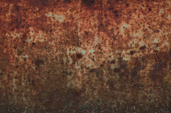 old rusty sheet of metal with peeling faded paint, covered with dust and dirt, grungy texture surface, close-up vintage background.