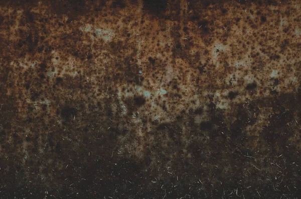 old rusty sheet of metal with peeling faded paint, covered with dust and dirt, grungy texture surface, close-up vintage background.