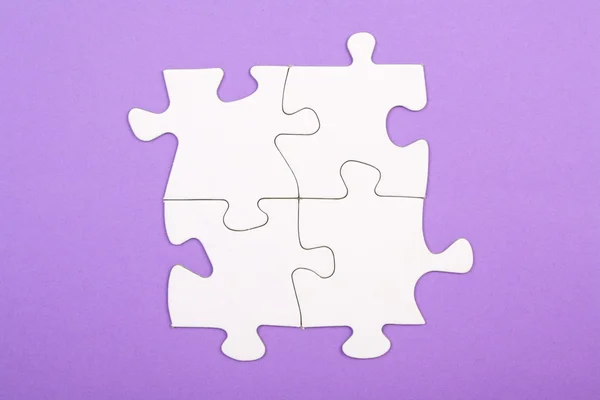 Quatre pièces de puzzle connectées — Photo