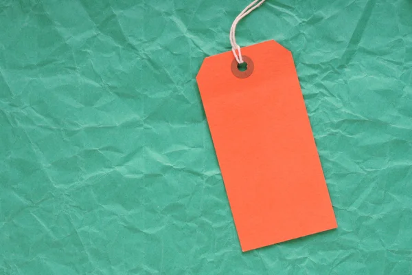 Yeşil zemin üzerine portakal etiketi — Stok fotoğraf