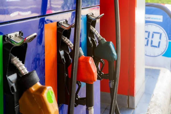 Petrol pump filling fuel nozzle in gas station. Fuel dispenser. Refuel fill up with petrol gasoline. Gas pump handle. Red petrol fuel nozzle. Petroleum oil industry. Oil crisis. Petrol price crisis.