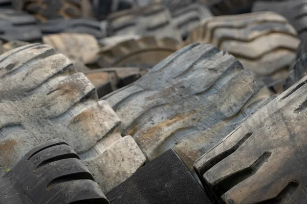 Closeup used truck tires. Old tyres waste for recycle or for landfill. Black rubber tire of truck. Pile of used tires at recycling yard. Material for landfill. Recycled tires. disposal waste tires.