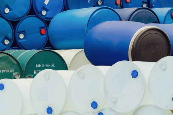 Old chemical barrels. Stack of methanol or methyl alcohol drum. Steel chemical tank. Toxic waste. Plastic and steel chemical barrels. Industrial waste in drum. Hazard waste storage at factory yard.