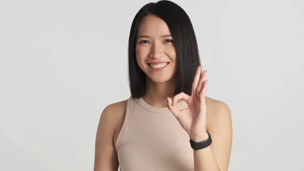 Confident Asian Girl Showing Okay Gesture Smiling Camera White Background — Stock Photo, Image