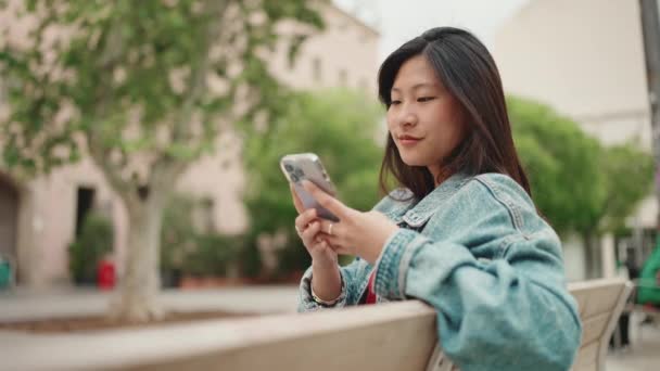 Piękna Długowłosa Azjatka Jeansowej Kurtce Sprawdzająca Media Społecznościowe Świeżym Powietrzu — Wideo stockowe