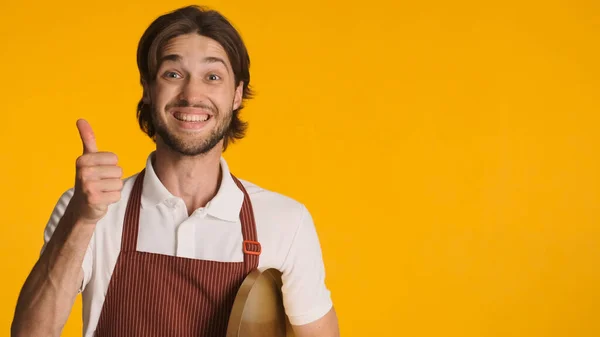 Positive Male Waiter Wearing Apron Keeping Thumb Approved Something Camera — Stock Photo, Image