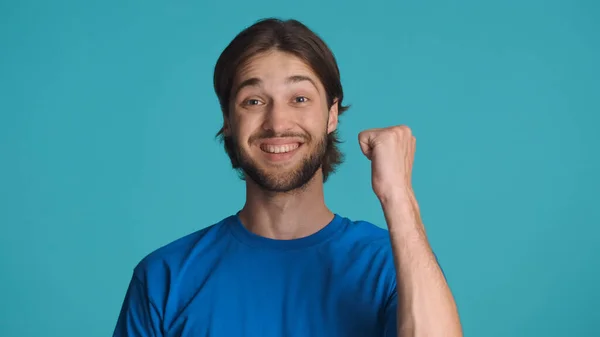 Cheerful Man Raising Fist Celebrating Success Isolated Blue Background Young — Stock Photo, Image