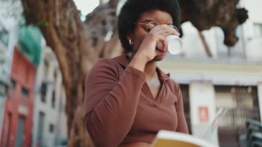 Sokakta kitap okuyan gözlüklü Afrikalı bir kadının fotoğrafını çekiyorum. Açık havada kahve molası veren esmer tenli bir kız öğrenci.