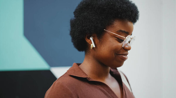 Side View Afro Woman Glasses Listening Music Wearing Wireless Earphones Royalty Free Stock Photos