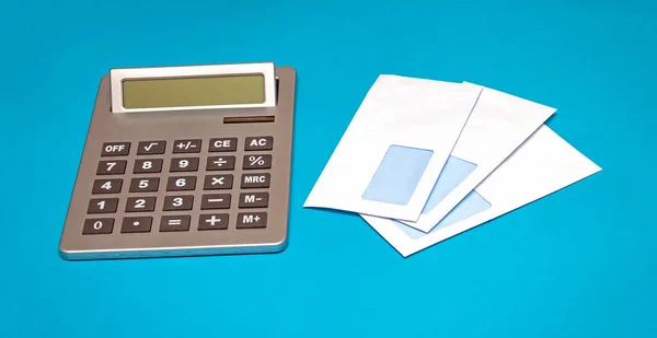 Pile Blank White Envelopes Next Electric Calculator Blue Background — Stock Photo, Image