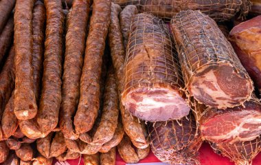 Smoked bacon and sausages sold  on local market stall