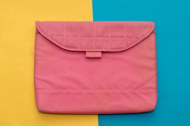 Laptop computer protective case in pink color over colorful background