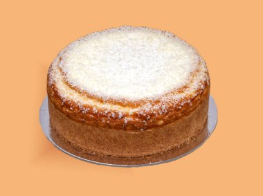 Baked cheesecake on silver stand isolated on yellow background