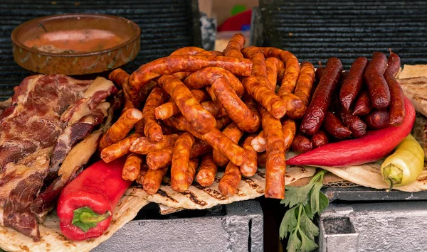 Pile of grilled sausages on market stall